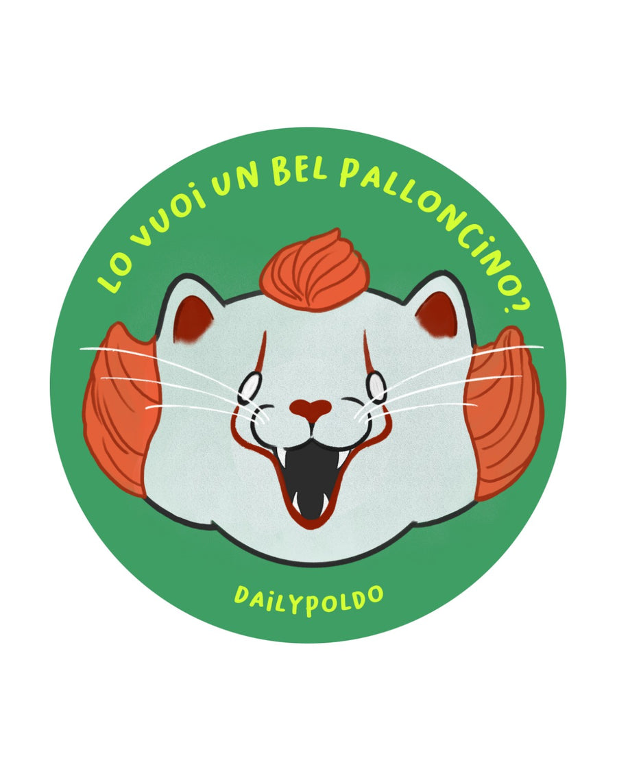 Gatto con ciuffo e boccoli arancioni, viso bianco truccato da clown e bocca spalancata con zanne, su sfondo verde con scritta